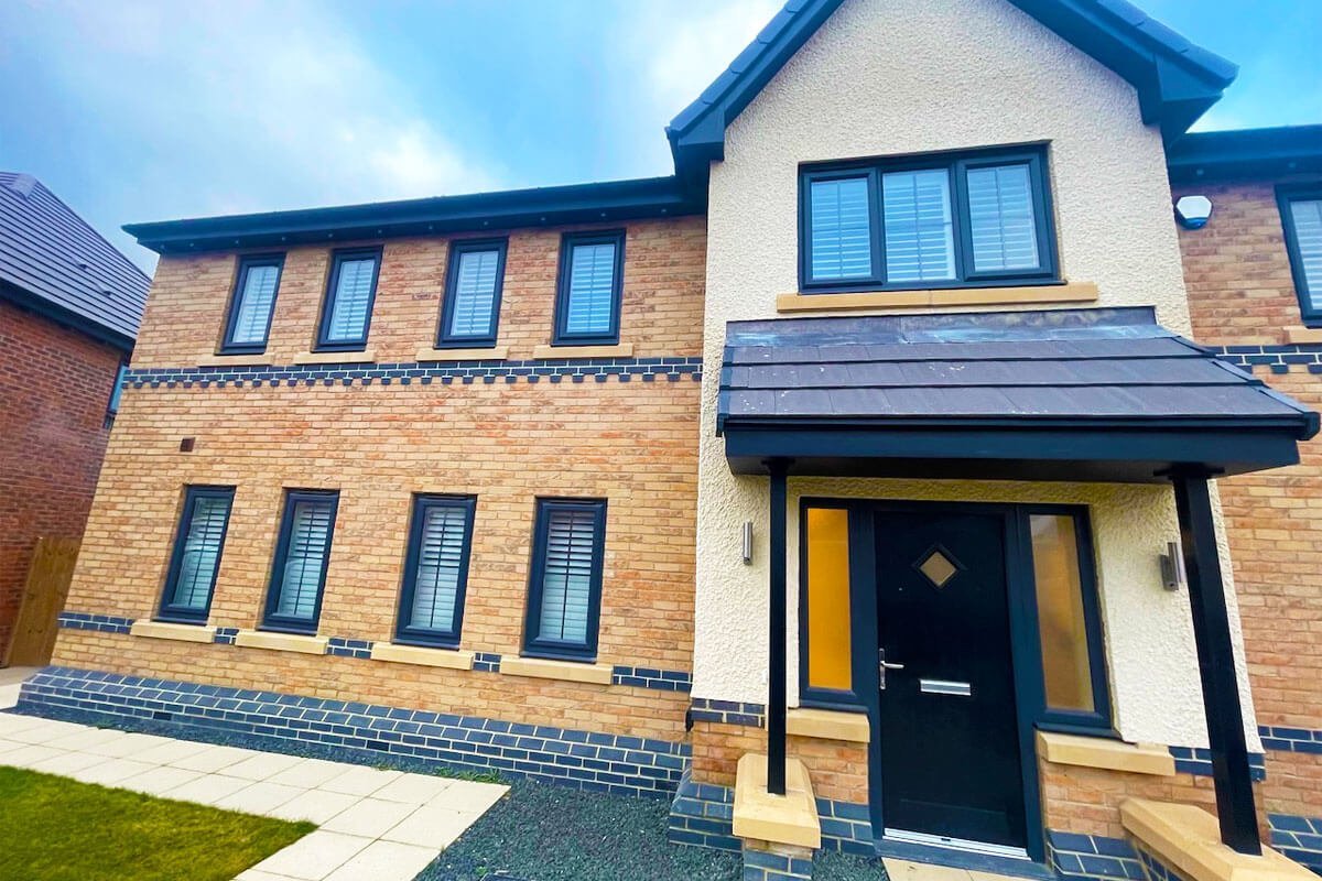 White venetian blinds in windows of modern new build house.