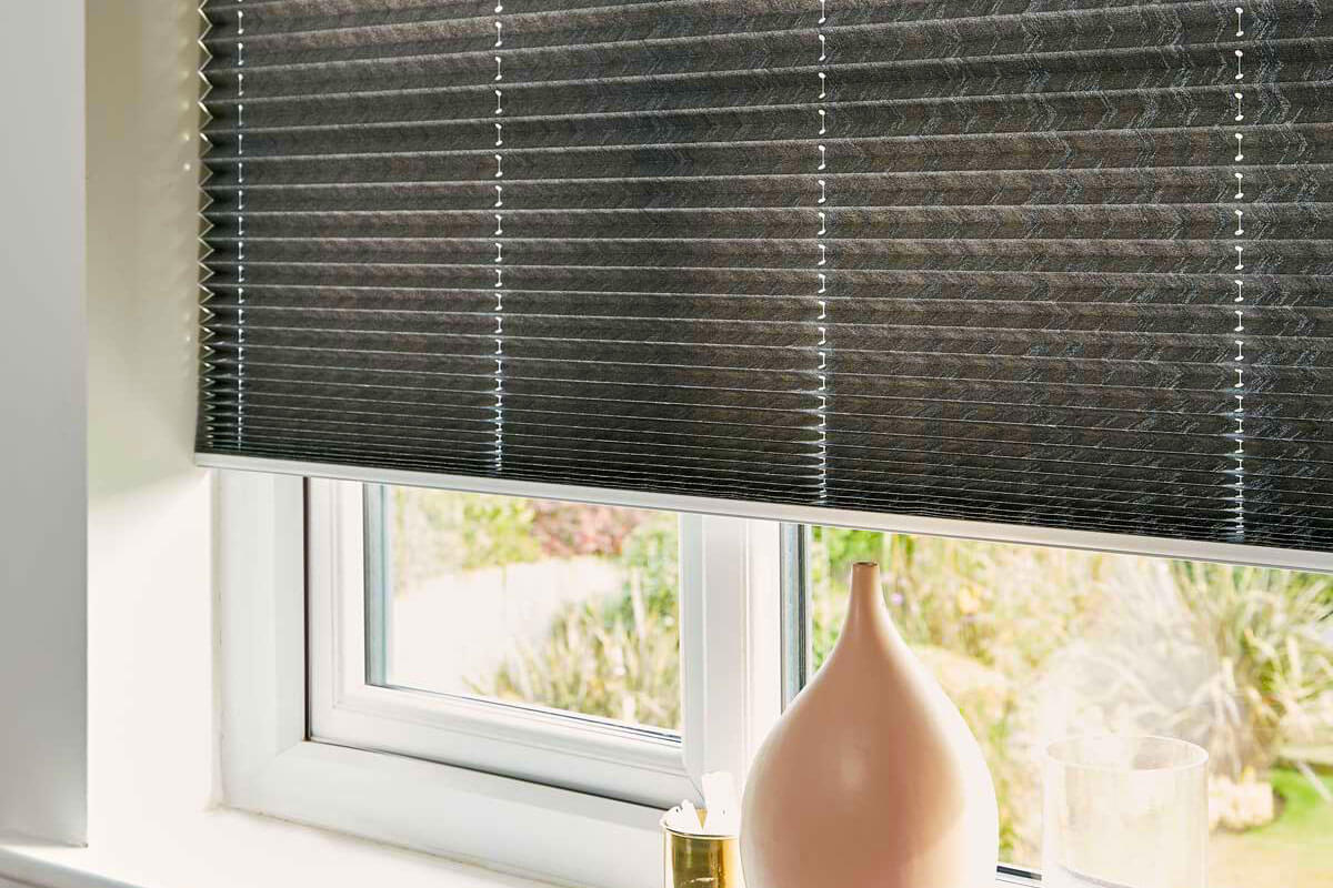 Grey pleated blinds in bathroom.
