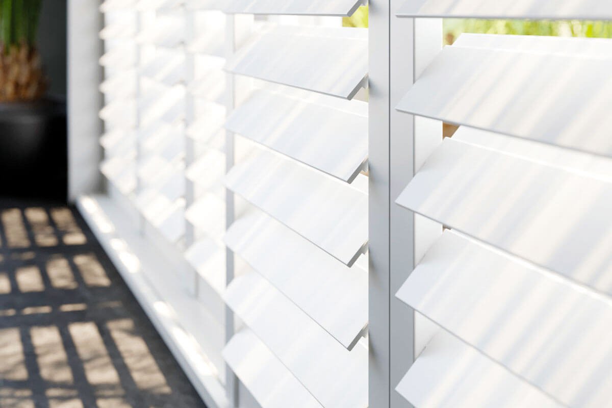 Close up of white, wooden shutter blinds.