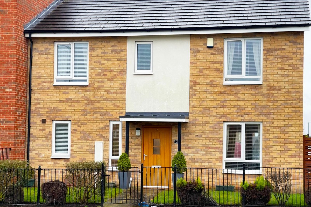Large semi-detached house with venetian blinds in all windows.