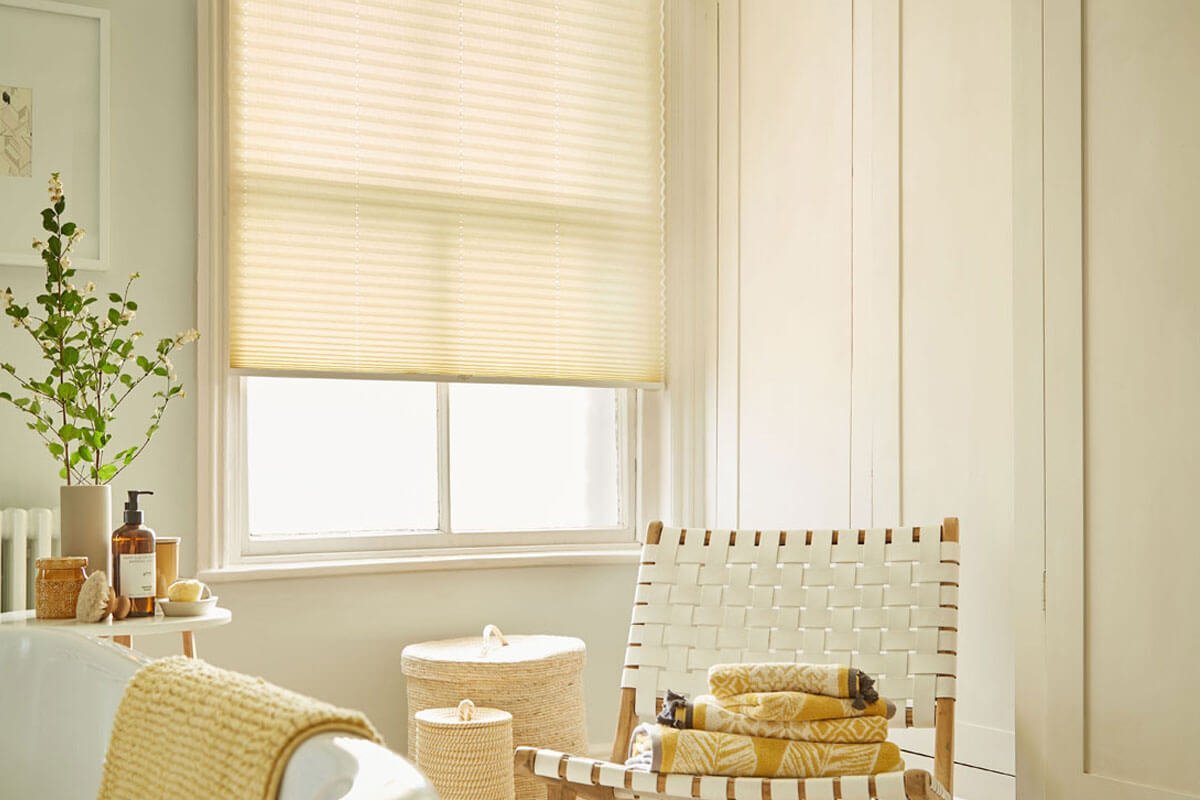 White pleated window blinds in light, modern bathroom.