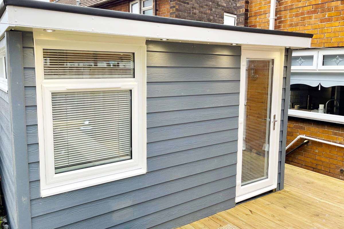White venetian blinds in windows of modern summer house.