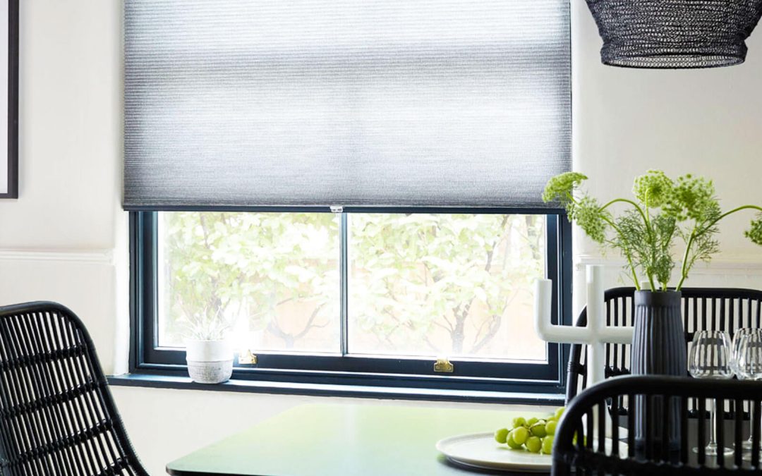Motorised Blinds, Pleated, grey window blinds half open showing outdoor garden area in modern dining area.