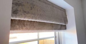 Close up of roman blind in small lounge window.