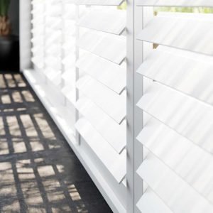 Close up of white wooden shutters.