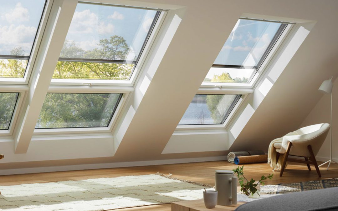 Velux Blinds, Skylight blinds in modern, loft conversion. Wooden floors and modern furniture in the foreground.