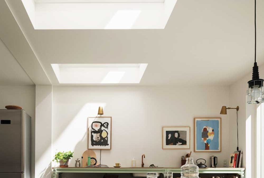 Skylight blinds in modern, white and green kitchen area.
